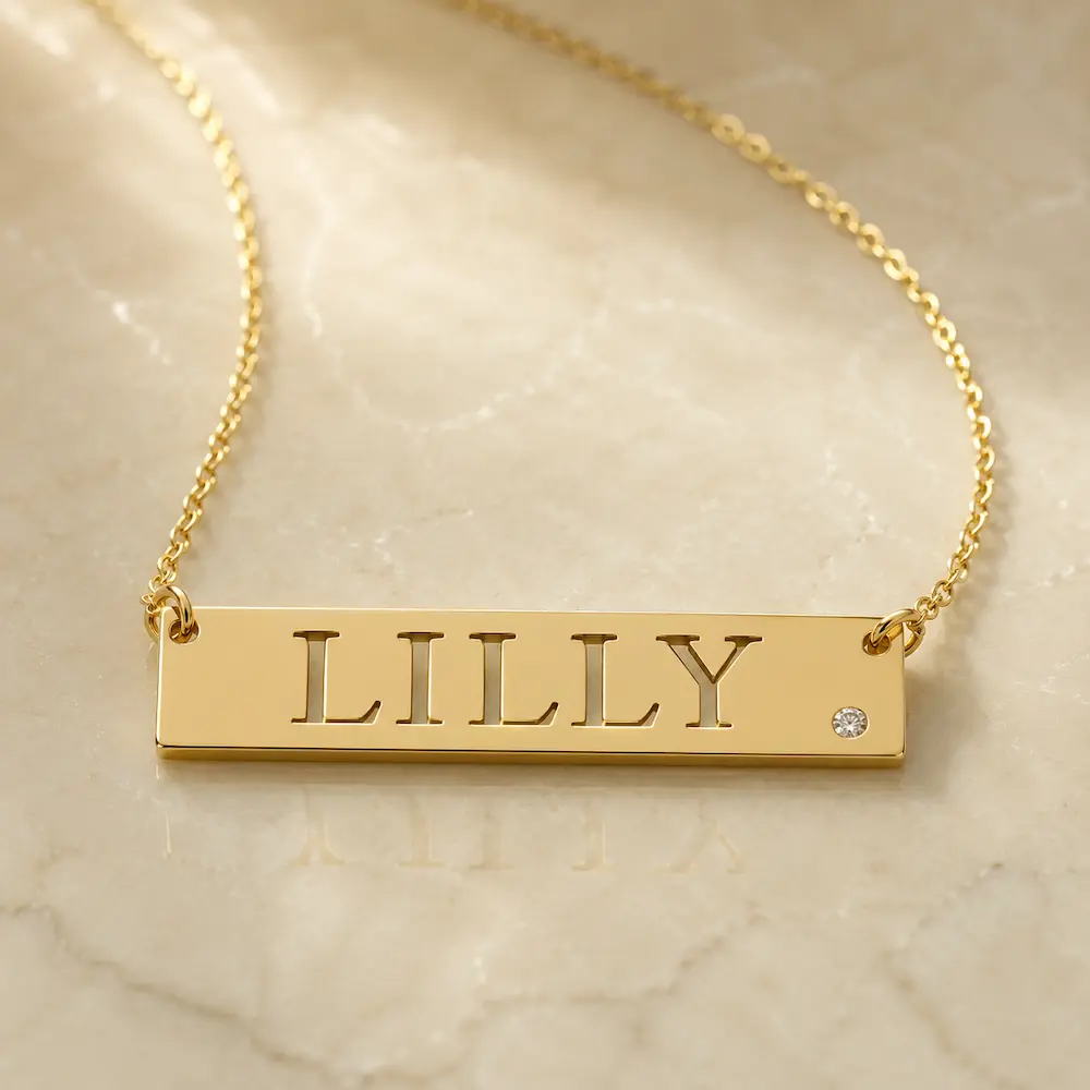 Lilly gold nameplate with a diamond by Basch & co